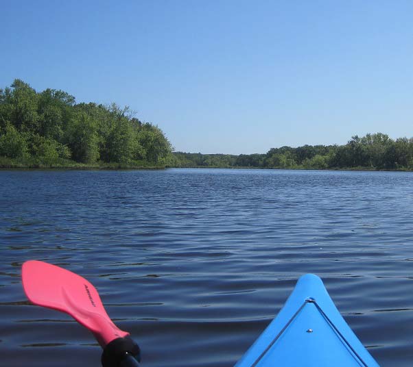 Kayak rip and paddle, Concord River with blue sky and green trees