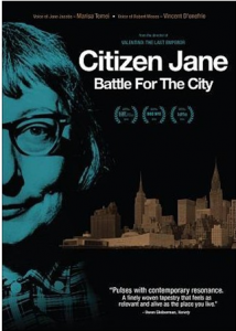 movie poster: half a woman's face with glasses and short hair illumninated by blue light, behind her is a city "Citizen Jane Battle for the City"