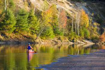 A man canoeing on the Merrimack River in Canterbury, New Hampshire.