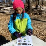 a young girl Completes a scavenger hunt at Hawk Valley Farm