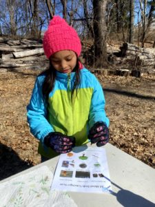 a young girl Completes a scavenger hunt at Hawk Valley Farm