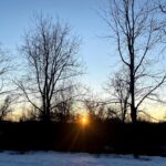 sunrise at hawk valley farm during winter solstice bare trees in snow